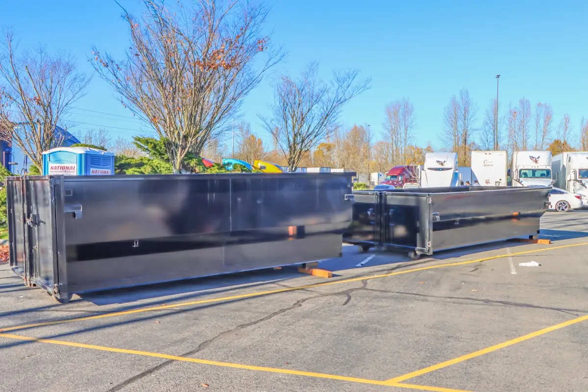 Professional dumpster rental service with roll-off container on residential driveway in Mount Clemens